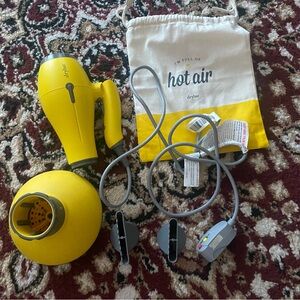 Drybar buttercup travel hair dryer with diffuser and straightening attachments.